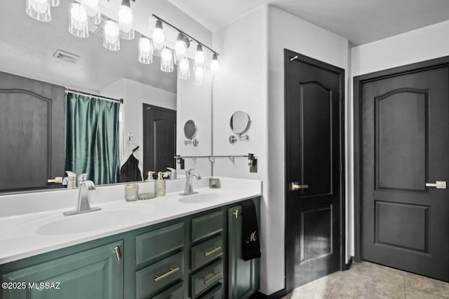 full bathroom featuring double vanity, visible vents, a sink, and tile patterned floors