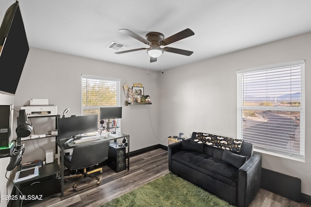 office space featuring a ceiling fan, wood finished floors, baseboards, and visible vents