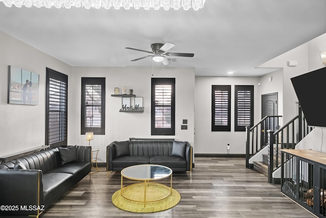 living room featuring hardwood / wood-style floors and ceiling fan