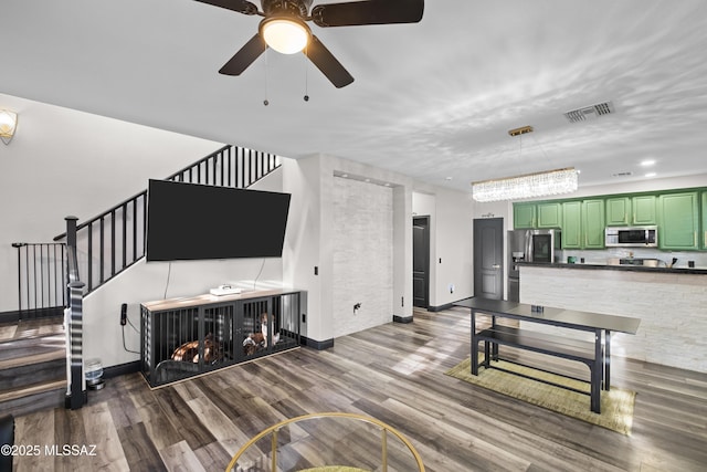 living room with ceiling fan and wood-type flooring