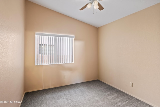 carpeted empty room with ceiling fan and vaulted ceiling