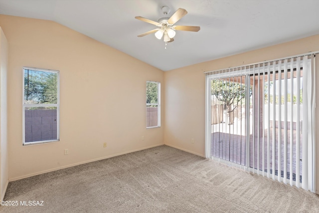 unfurnished room with vaulted ceiling, ceiling fan, and carpet