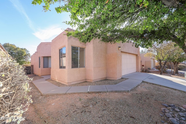 view of front of property featuring a garage and central air condition unit