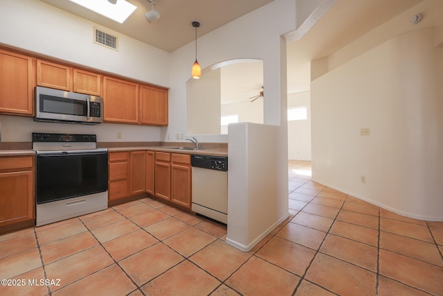 kitchen featuring electric stove, sink, pendant lighting, white dishwasher, and light tile patterned flooring