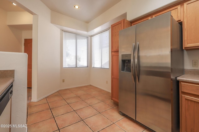 kitchen with appliances with stainless steel finishes and light tile patterned floors