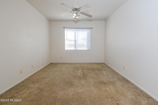 empty room with ceiling fan and light colored carpet