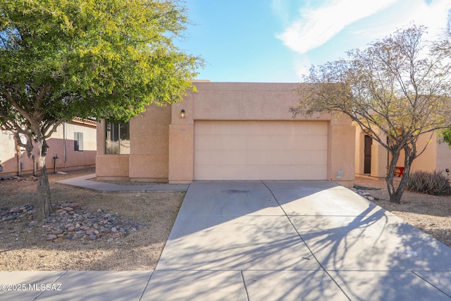 pueblo-style house with a garage