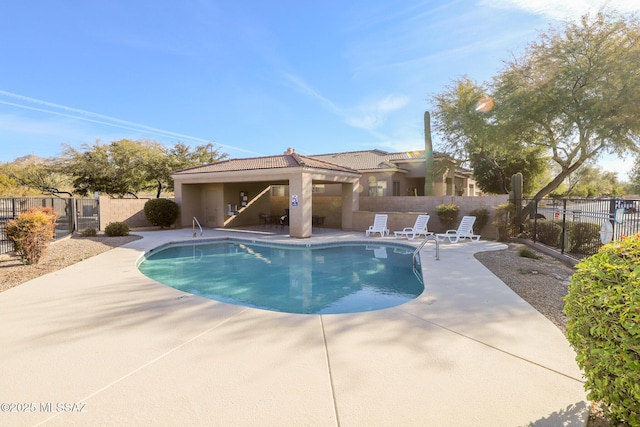 view of swimming pool with a patio area