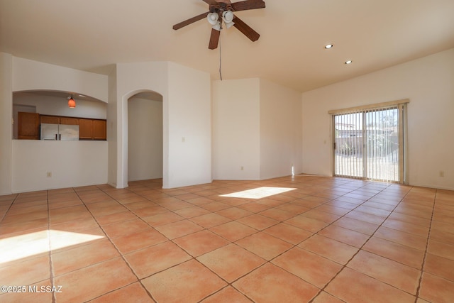 empty room featuring light tile patterned floors and ceiling fan