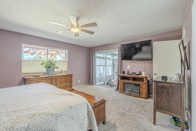 bedroom with multiple windows, a textured ceiling, and ceiling fan