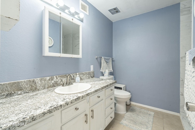 bathroom featuring vanity, tile patterned flooring, and toilet