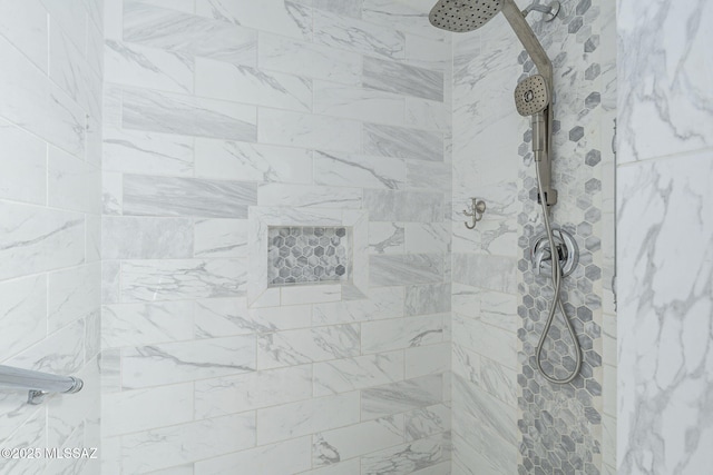 interior details with a tile shower