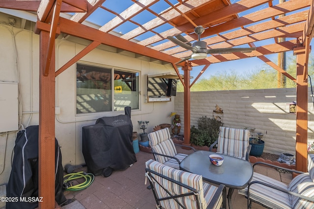 view of patio with ceiling fan, grilling area, and a pergola