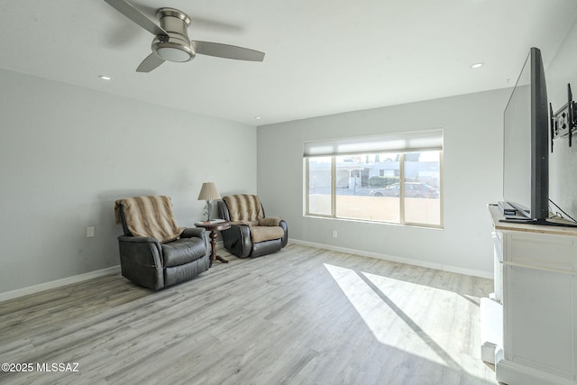 living area with ceiling fan and light wood-type flooring