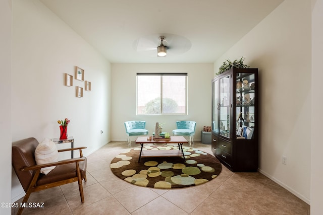 living area featuring light tile patterned flooring and ceiling fan