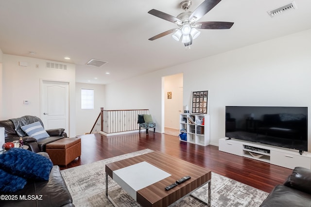 living room featuring wood-type flooring and ceiling fan