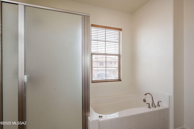 bathroom featuring a healthy amount of sunlight and shower with separate bathtub