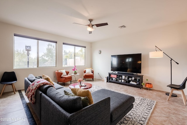 living room featuring light tile patterned floors and ceiling fan