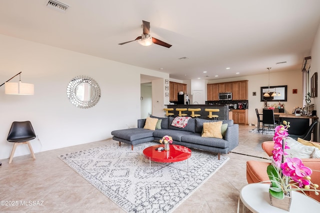 living room with light tile patterned floors and ceiling fan