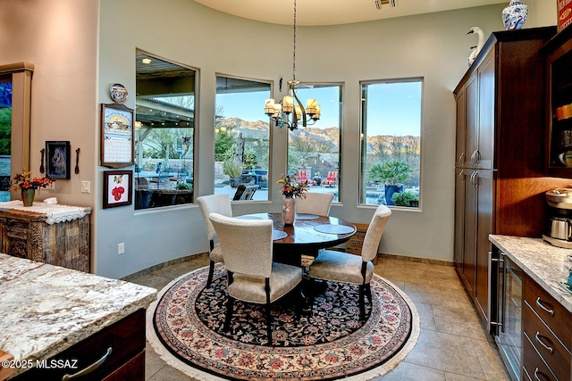 dining area with a chandelier and a mountain view