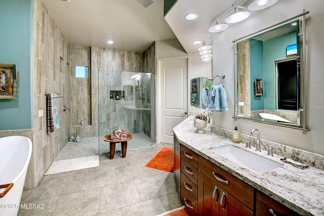 bathroom with vanity, plus walk in shower, and tile patterned flooring