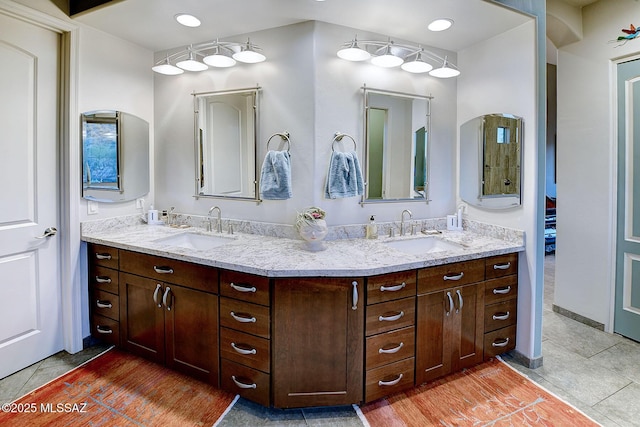 bathroom with tile patterned flooring and vanity