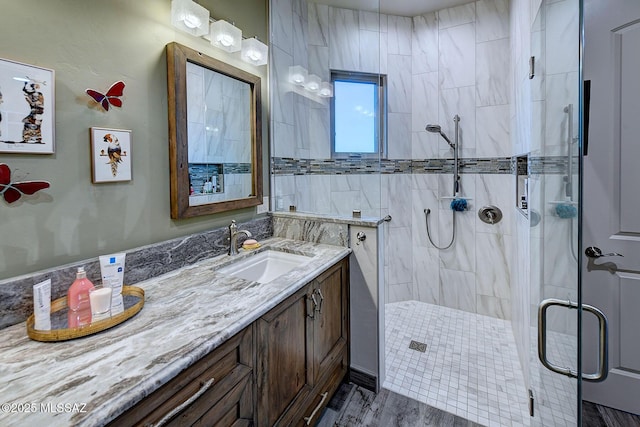 bathroom featuring vanity and an enclosed shower