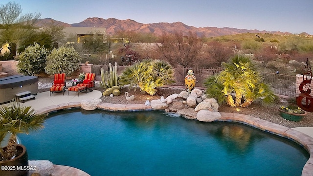 view of pool with a mountain view and a patio