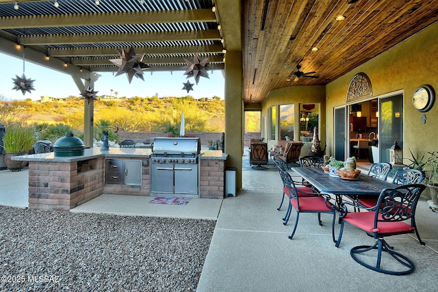 view of patio / terrace with area for grilling, ceiling fan, and a pergola