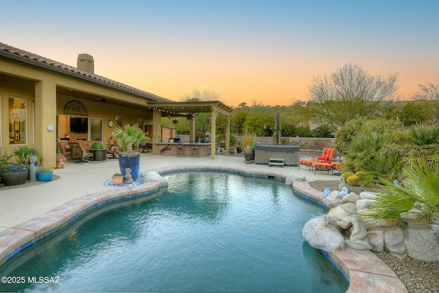 view of swimming pool with a patio area, a hot tub, and ceiling fan