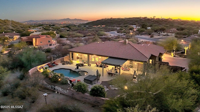 aerial view at dusk featuring a mountain view