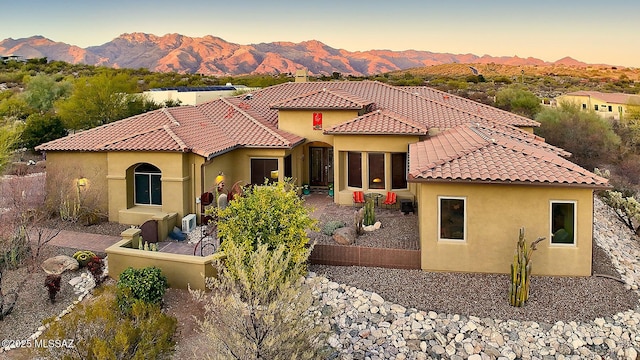 exterior space featuring a mountain view and a patio area