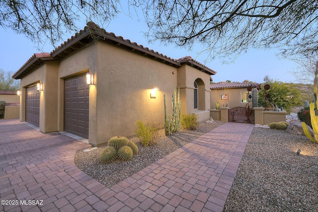 property exterior at dusk with a garage