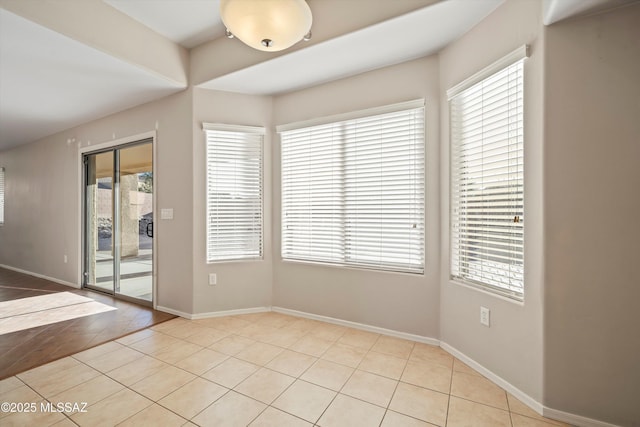 tiled empty room featuring a healthy amount of sunlight