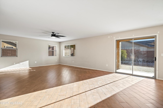 unfurnished living room featuring hardwood / wood-style floors and ceiling fan