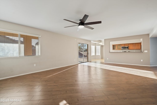 unfurnished living room with ceiling fan and light hardwood / wood-style floors