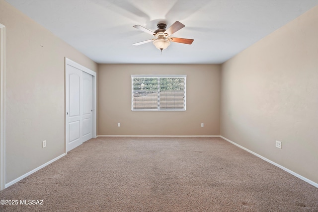 unfurnished bedroom featuring carpet flooring, ceiling fan, and a closet