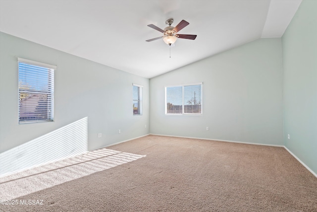 spare room featuring ceiling fan, plenty of natural light, carpet flooring, and vaulted ceiling