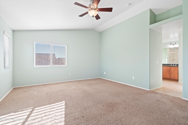 carpeted empty room with lofted ceiling and ceiling fan