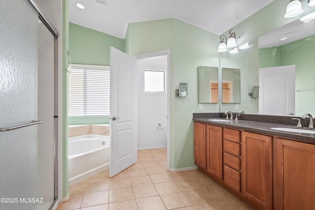 bathroom with tile patterned flooring, vanity, and separate shower and tub