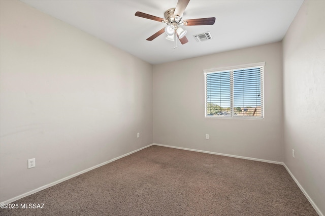 spare room with ceiling fan and carpet