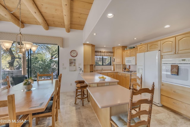 dining area with an inviting chandelier, wood ceiling, beam ceiling, and sink