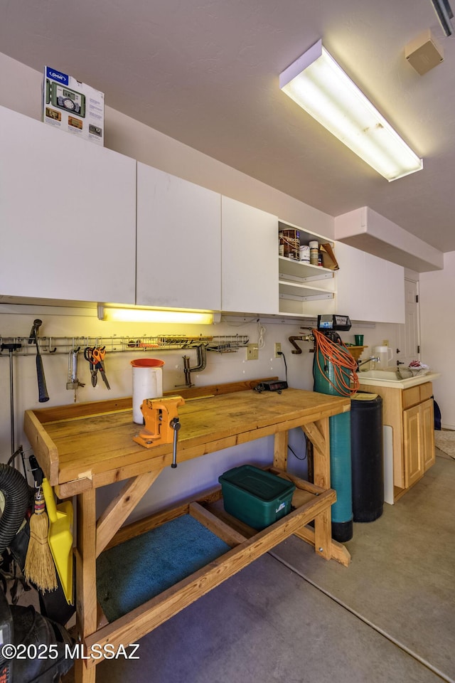 interior space with concrete floors and white cabinets