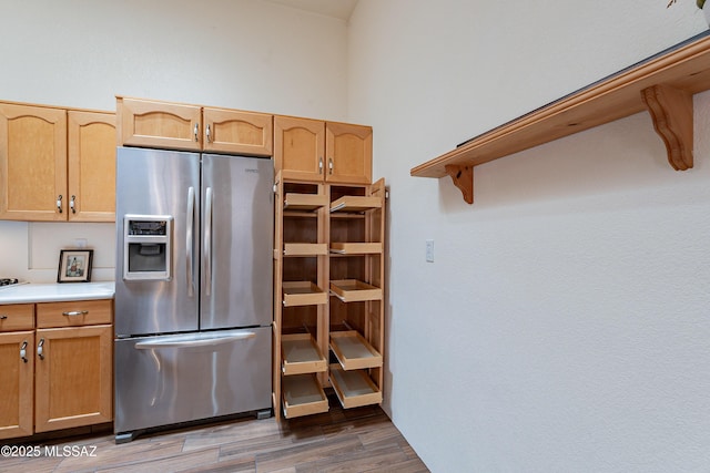 kitchen featuring dark wood-type flooring and stainless steel refrigerator with ice dispenser