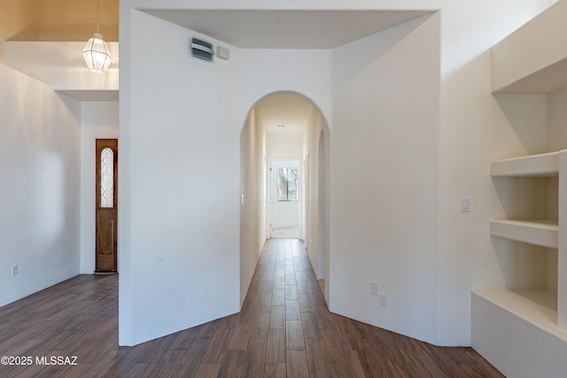 hallway with dark hardwood / wood-style flooring