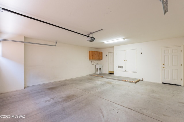 garage featuring a garage door opener and sink