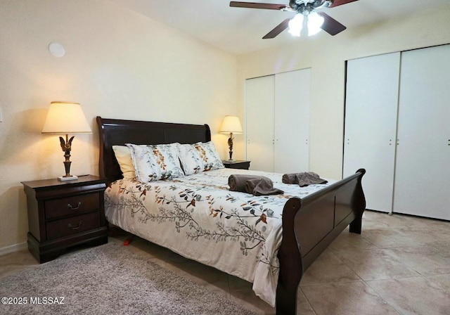 bedroom featuring ceiling fan and two closets