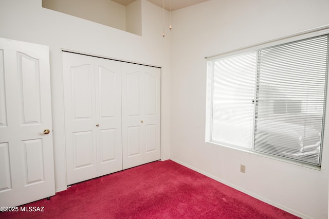 unfurnished bedroom featuring a closet and carpet flooring