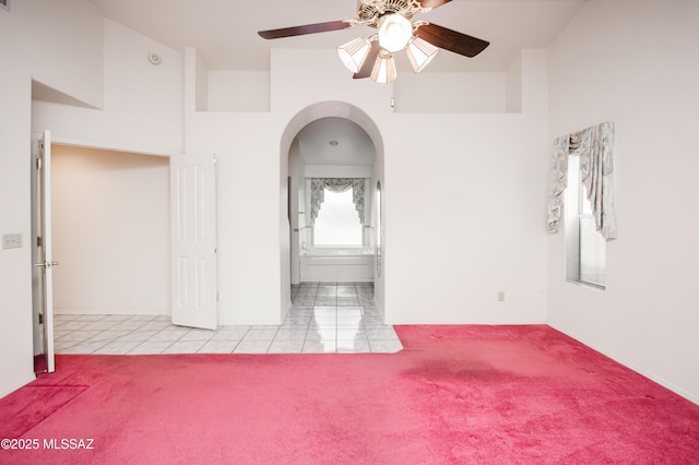 carpeted spare room with ceiling fan