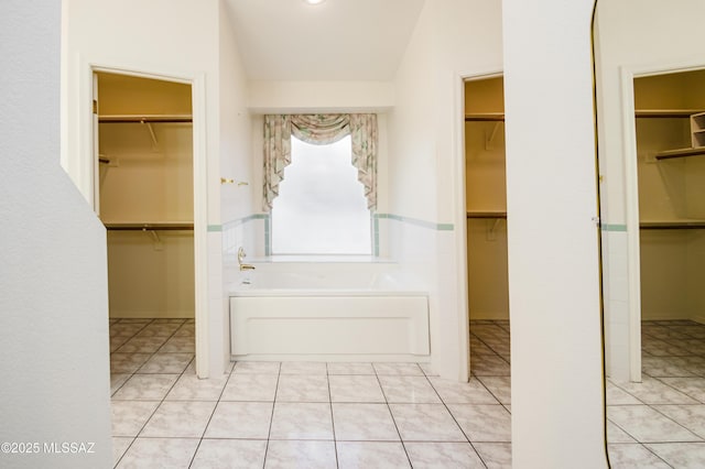 bathroom featuring tile patterned flooring and a tub